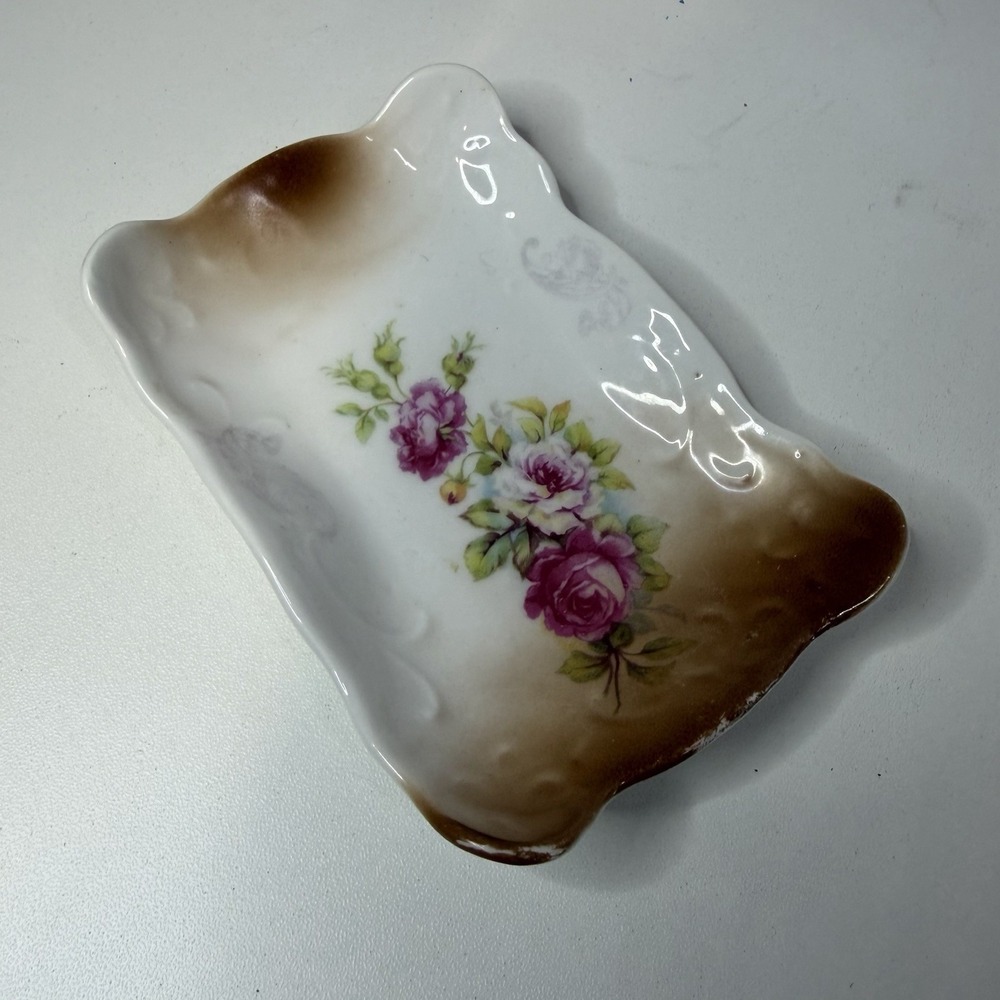This is an antique or vintage porcelain celery or relish dish